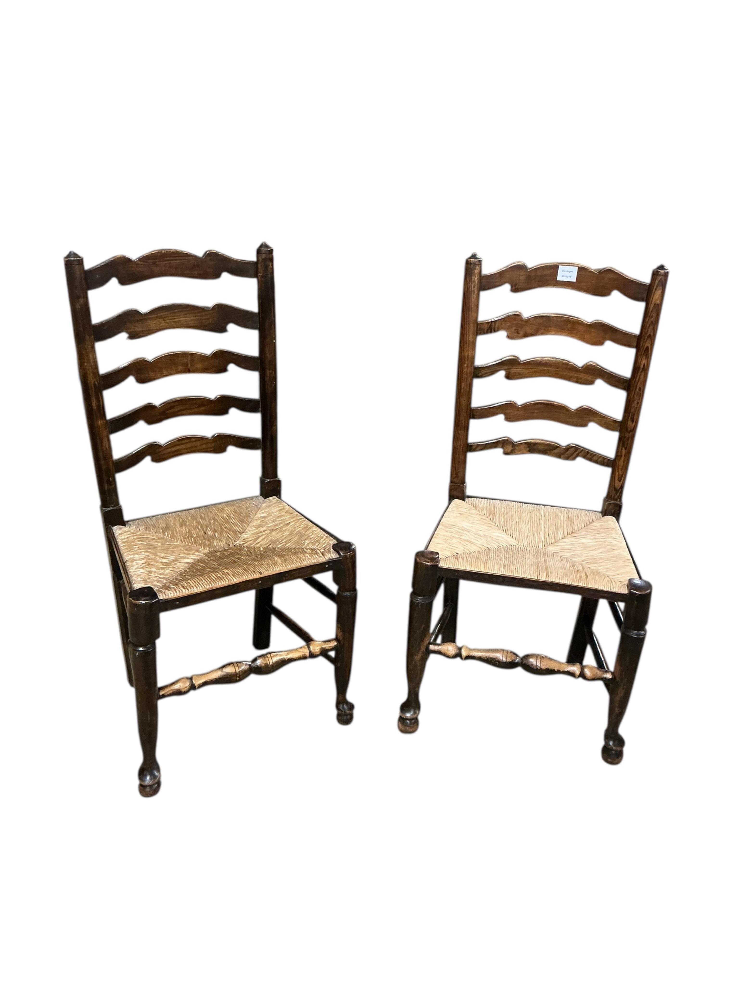 A set of six Lancashire style elm and beech rush seat ladderback dining chairs, two with arms